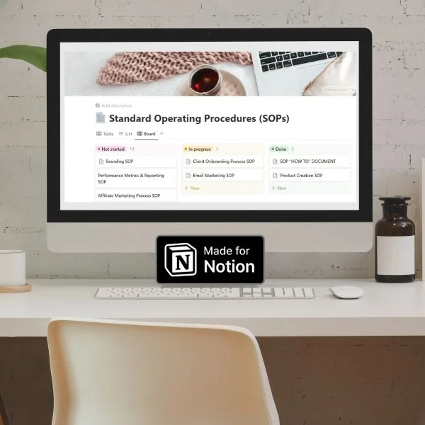 A computer monitor displaying a 'Notion' dashboard labeled 'Standard Operating Procedures (SOPs)' with various task categories, set on a minimalist desk with a "Made for Notion" sticker, illustrating an organized digital workspace